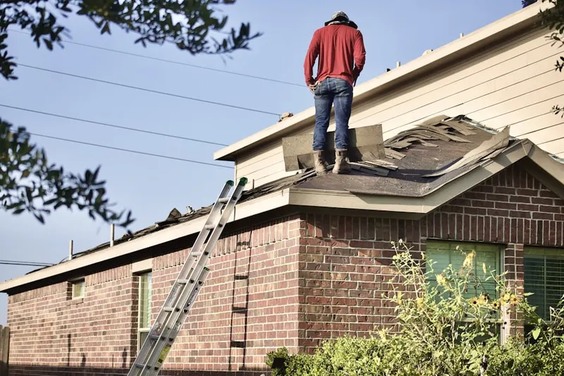 Professional roofer working on a residential roof in Hunt Ridge